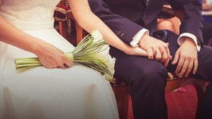 Bride and groom holding hands