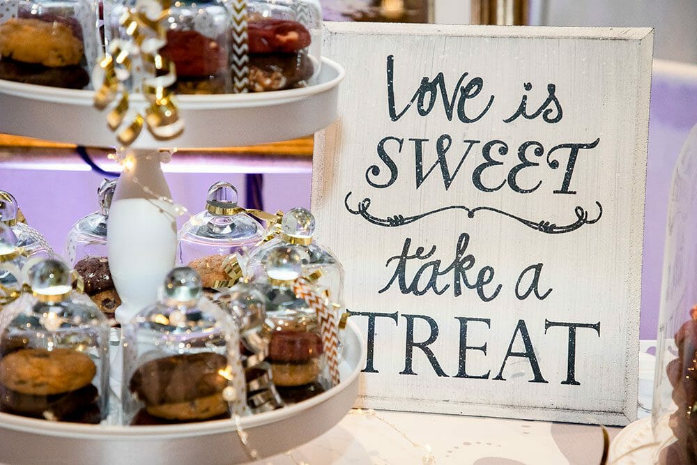 Love is Sweet Take a Treat sign with cakes